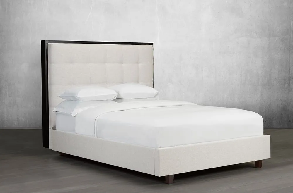 Classic Bed with tufted headboard and stained wood trim